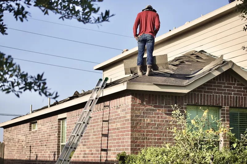 Professional roofer working on a residential roof in Lovington